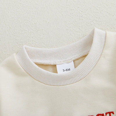 Niemowlęce body z długim rękawem i świątecznym napisem