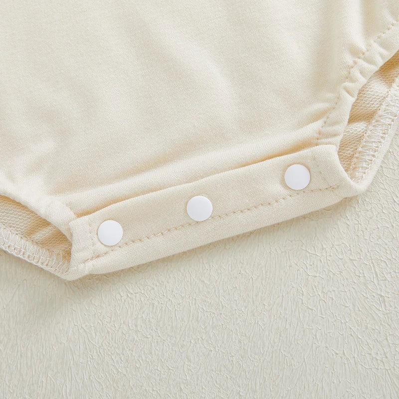 Niemowlęce body z długim rękawem i świątecznym napisem